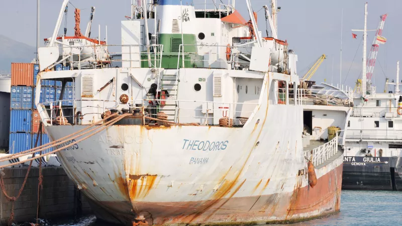 Abandoned ship docked at the wharf. Port of Genoa, Italy.