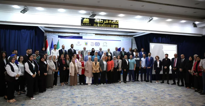 A group of participants lined up to pose at an event in Baghdad, Iraq