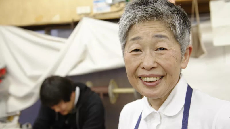 Older worker in a leather bag manufacturing workshop