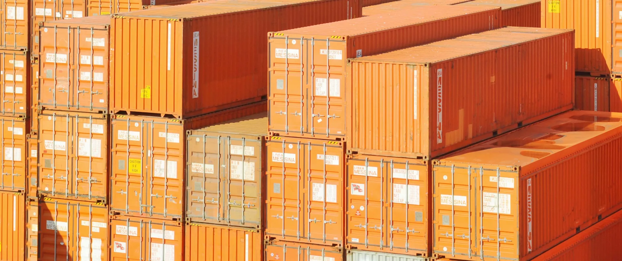 Shipping containers wait for transport at port