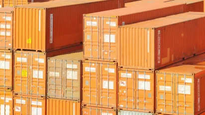 Shipping containers wait for transport at port