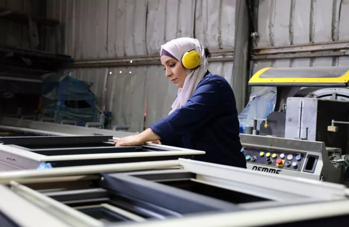 a woman working with an aluminium frame